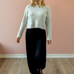 Olivaceous Jodi Satin Pants in black, front view, walking.