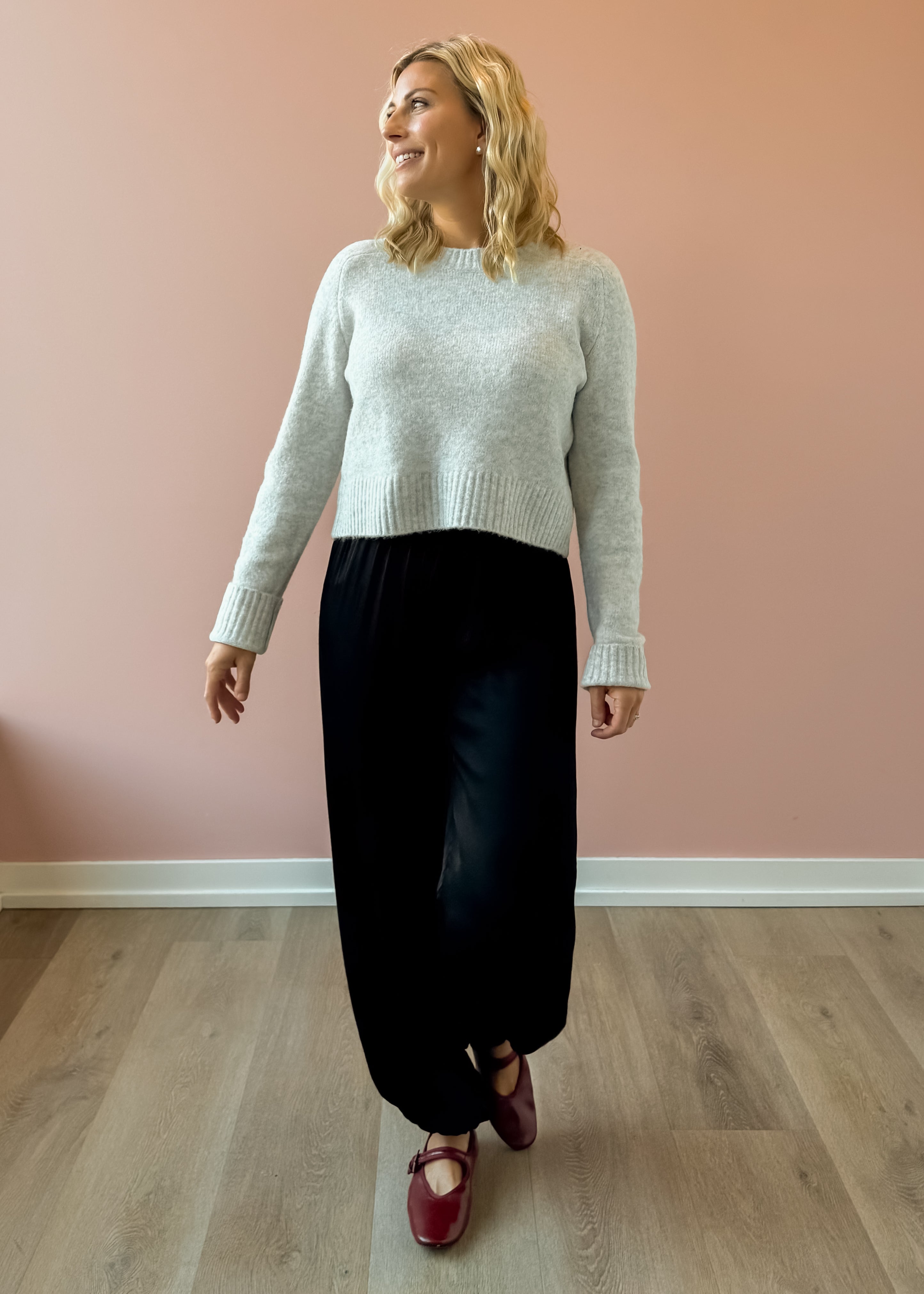 Olivaceous Jodi Satin Pants in black, front view, walking.