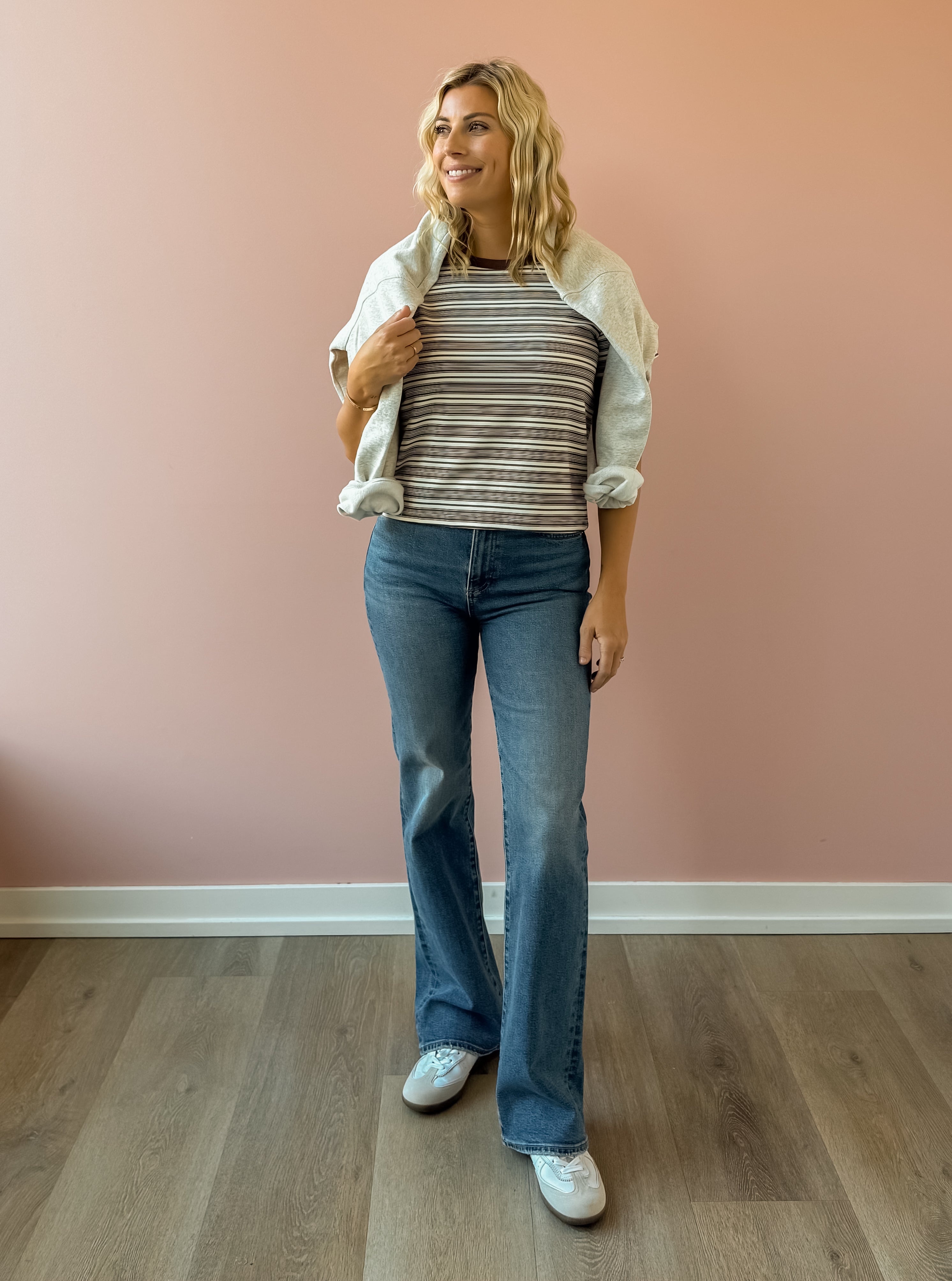 Olivaceous Mila Stripe Baby Tee in brown and white stripe, front view, sweatshirt over shoulders.