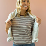 Olivaceous Mila Stripe Baby Tee in brown and white stripe, close-up front view, sweatshirt over shoulders.