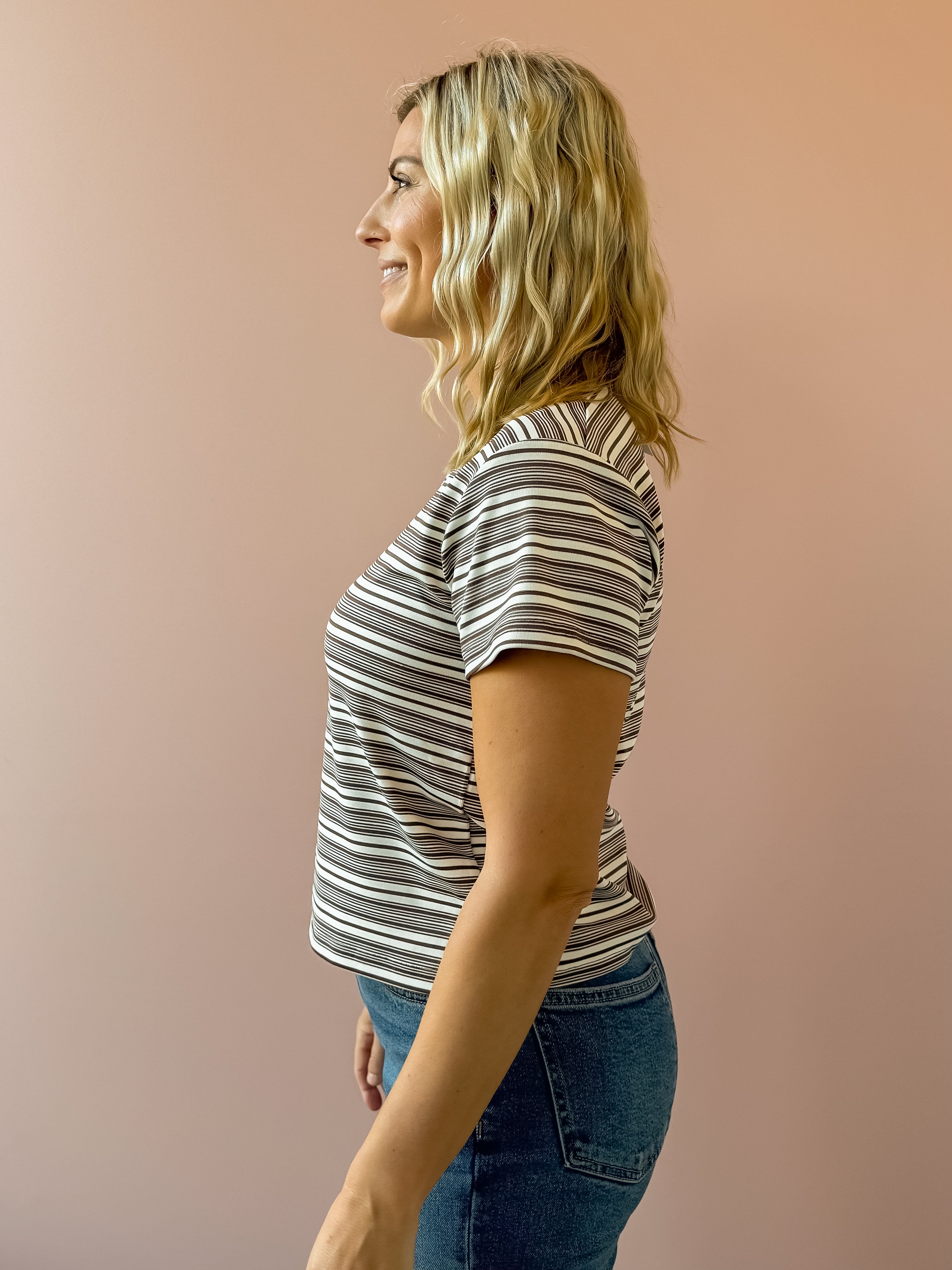 Olivaceous Mila Stripe Baby Tee in brown and white stripe, side view.