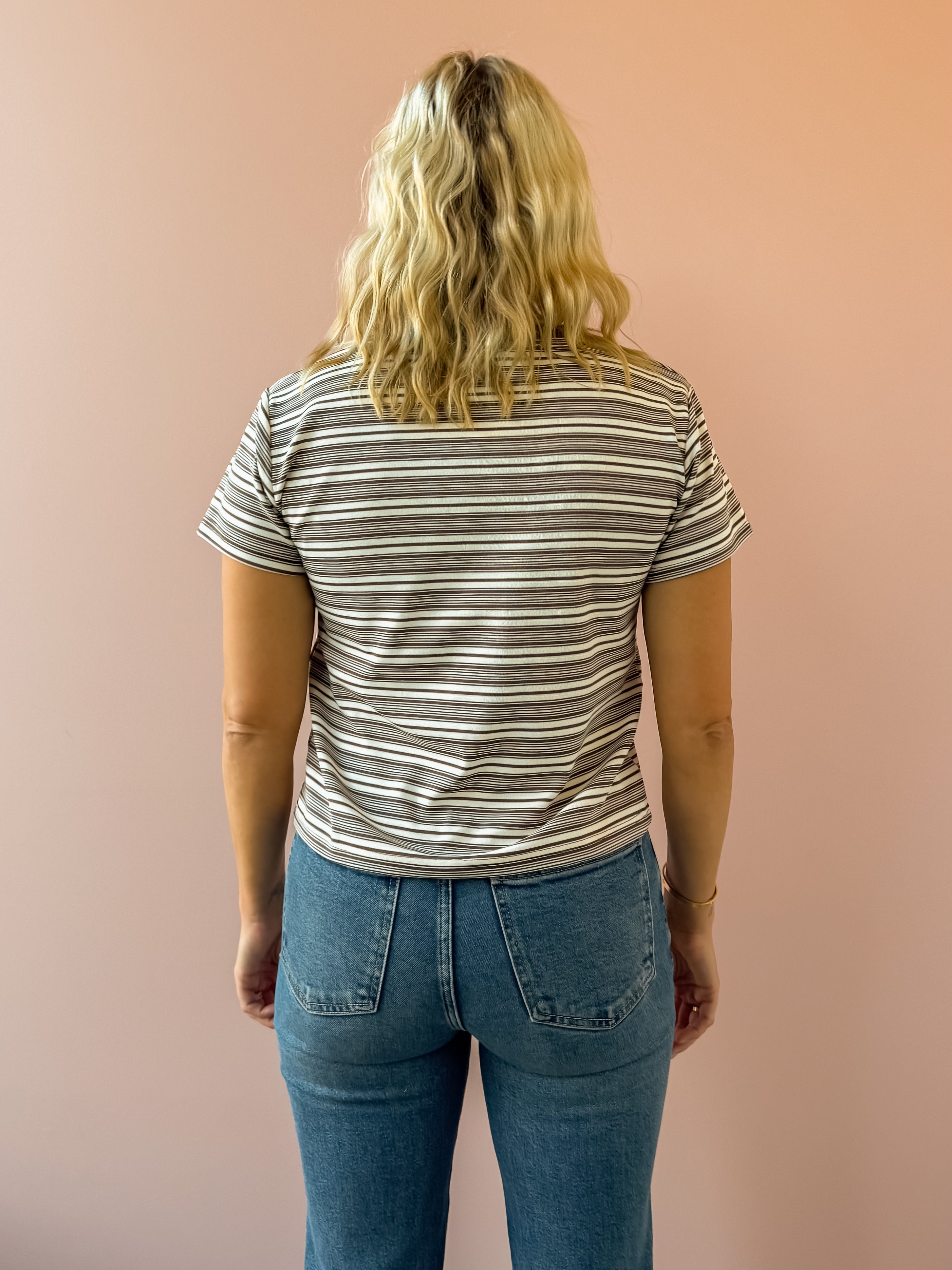 Olivaceous Mila Stripe Baby Tee in brown and white stripe, back view.