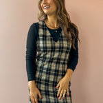 Sadie & Sage Served Up Stretch Plaid Mini Dress in black and tan plaid, front close-up, layered over a black long sleeve top.