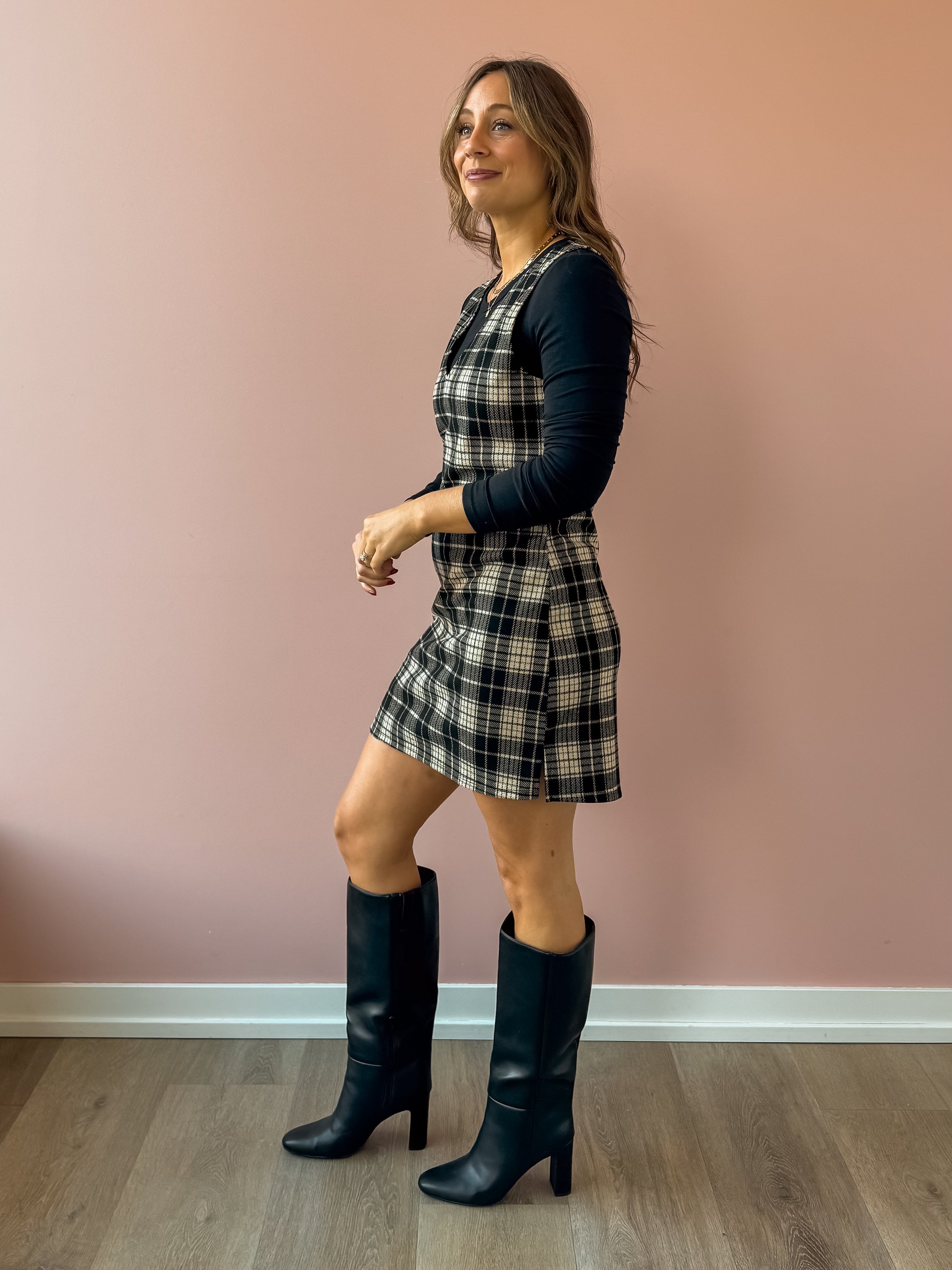 Sadie & Sage Served Up Stretch Plaid Mini Dress in black and tan plaid, side view, layered over a black long sleeve top.