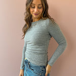 Sadie & Sage Page Turner Ruched Top in grey, close-up of side ruching.