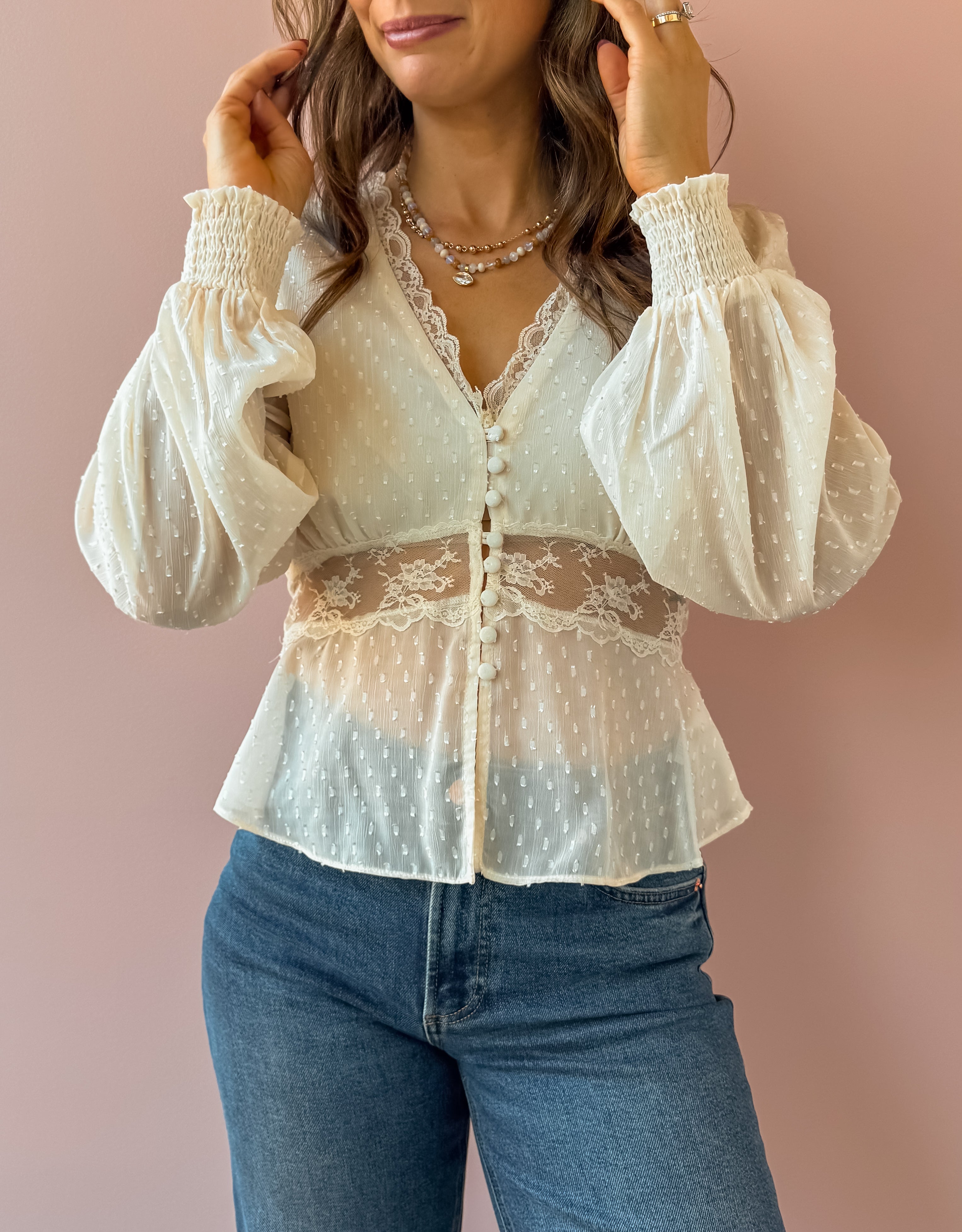 Sage The Label Monaco Peplum Top in cream, close-up of lace waist detail.