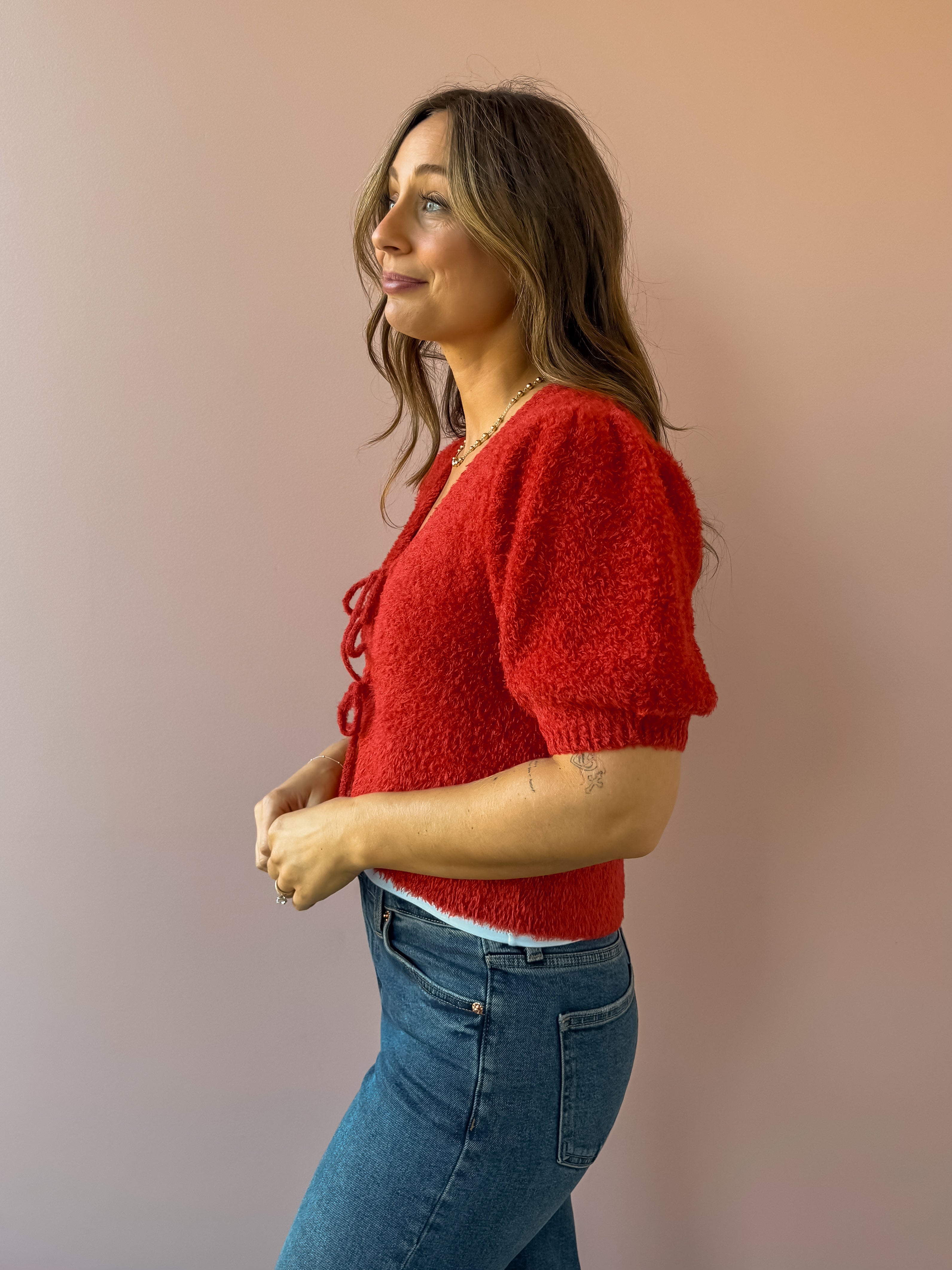 Saltwater Luxe Aeris Front Tie Sweater in red, side close-up.