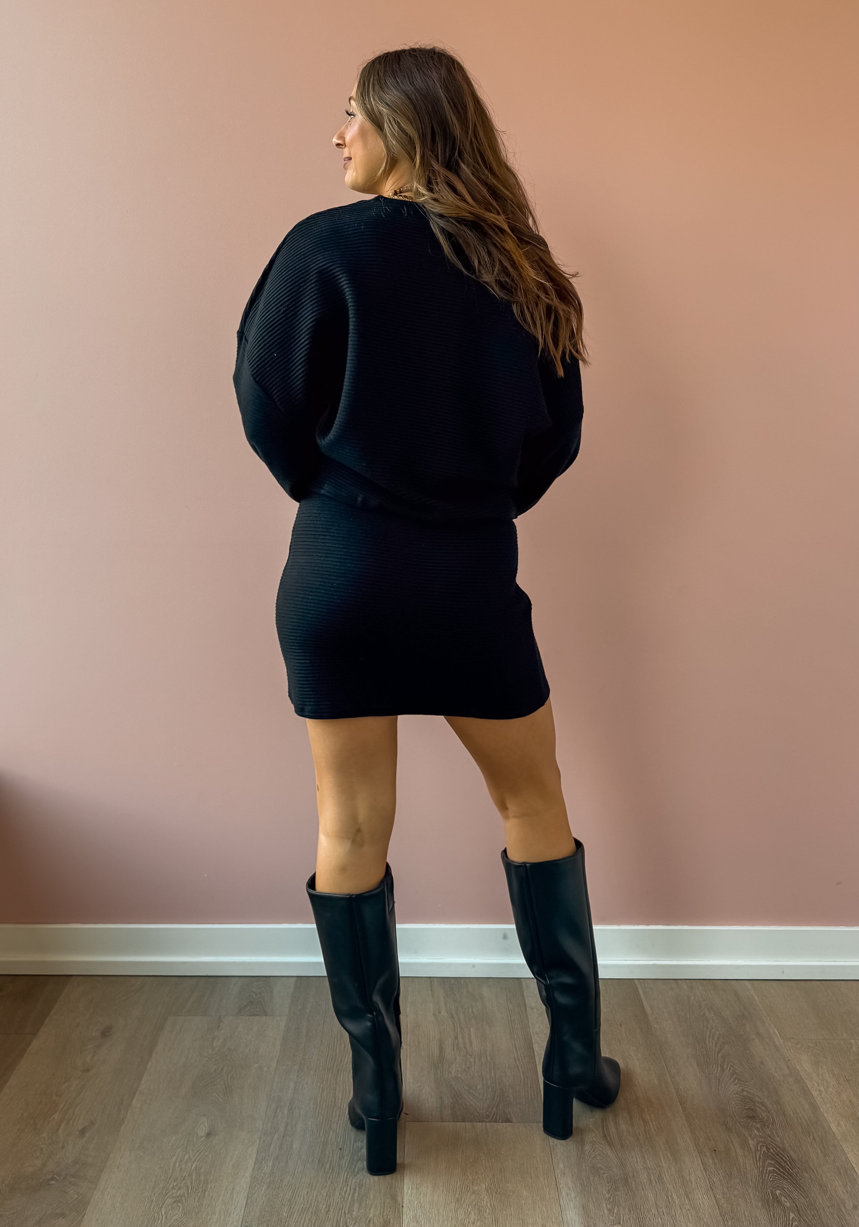 Sadie & Sage On A Stroll Mini Skirt in black, full-length back view.