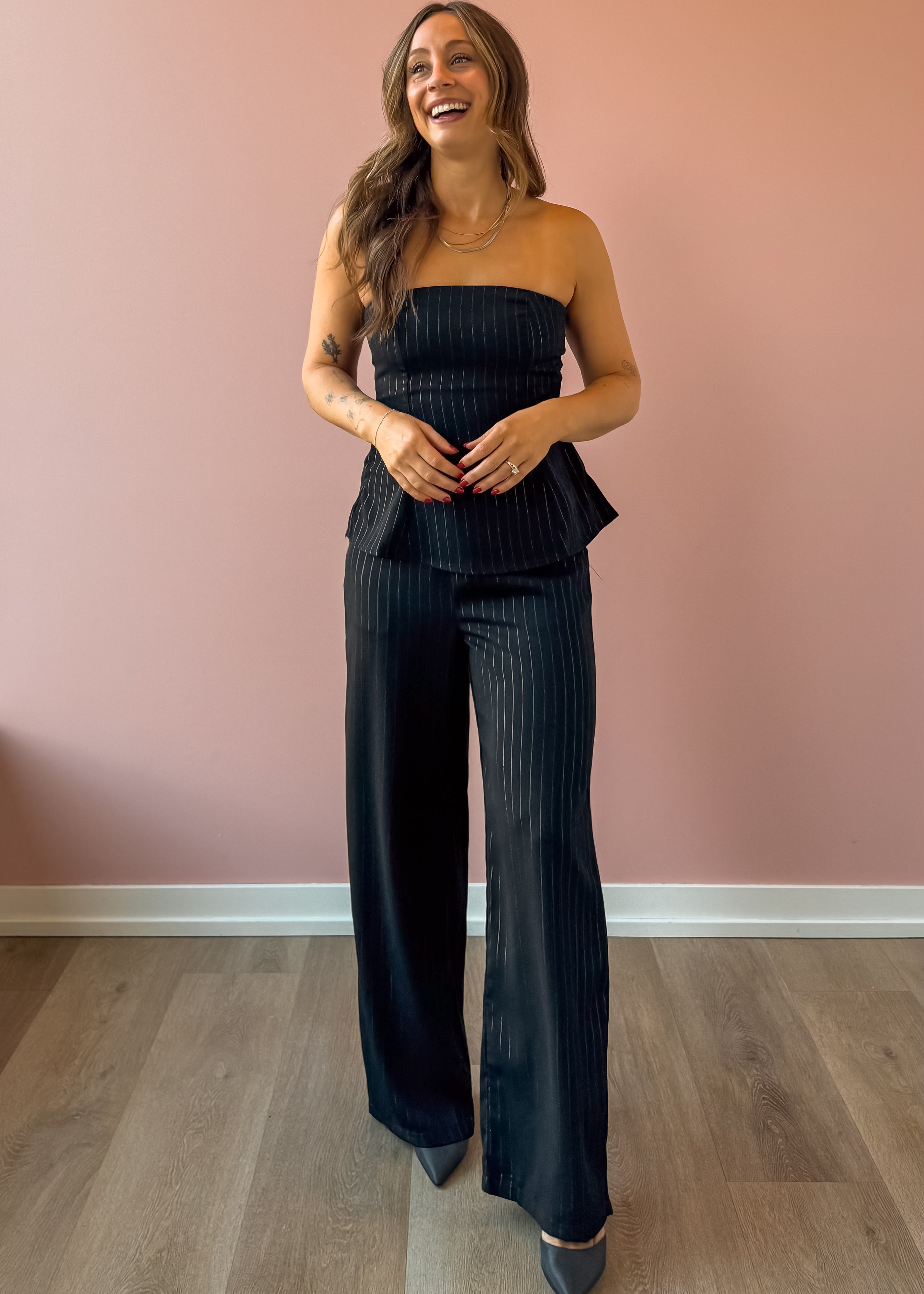 Sadie & Sage Gilded Evening Pinstripe Pants in black with silver pinstripes, full-length front view.