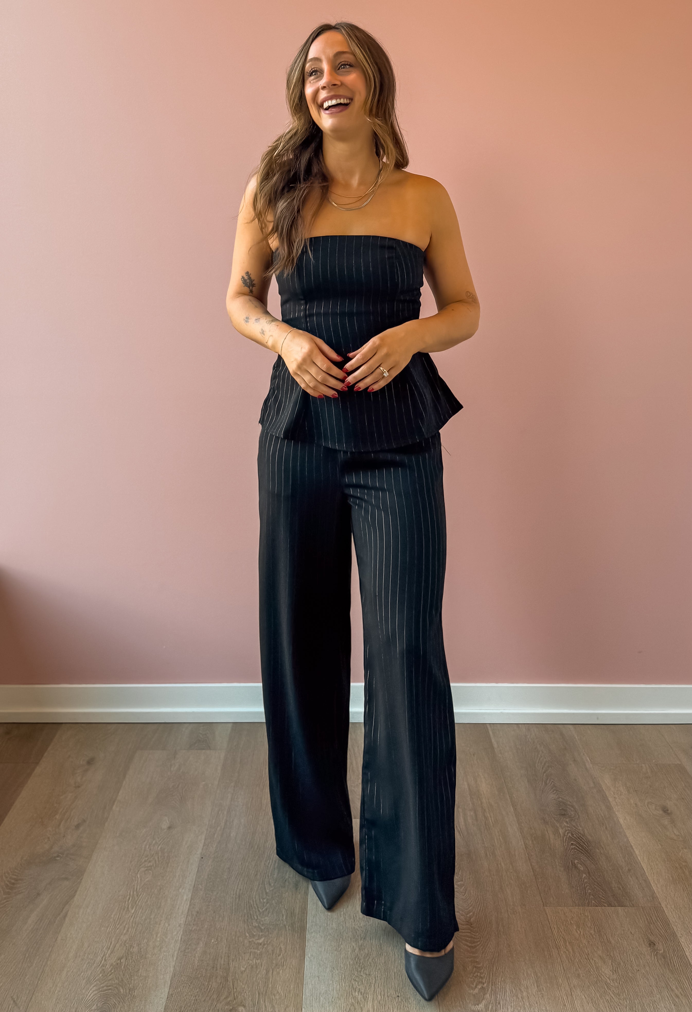 Sadie & Sage Gilded Evening Pinstripe Pants in black with silver pinstripes, full-length front view.