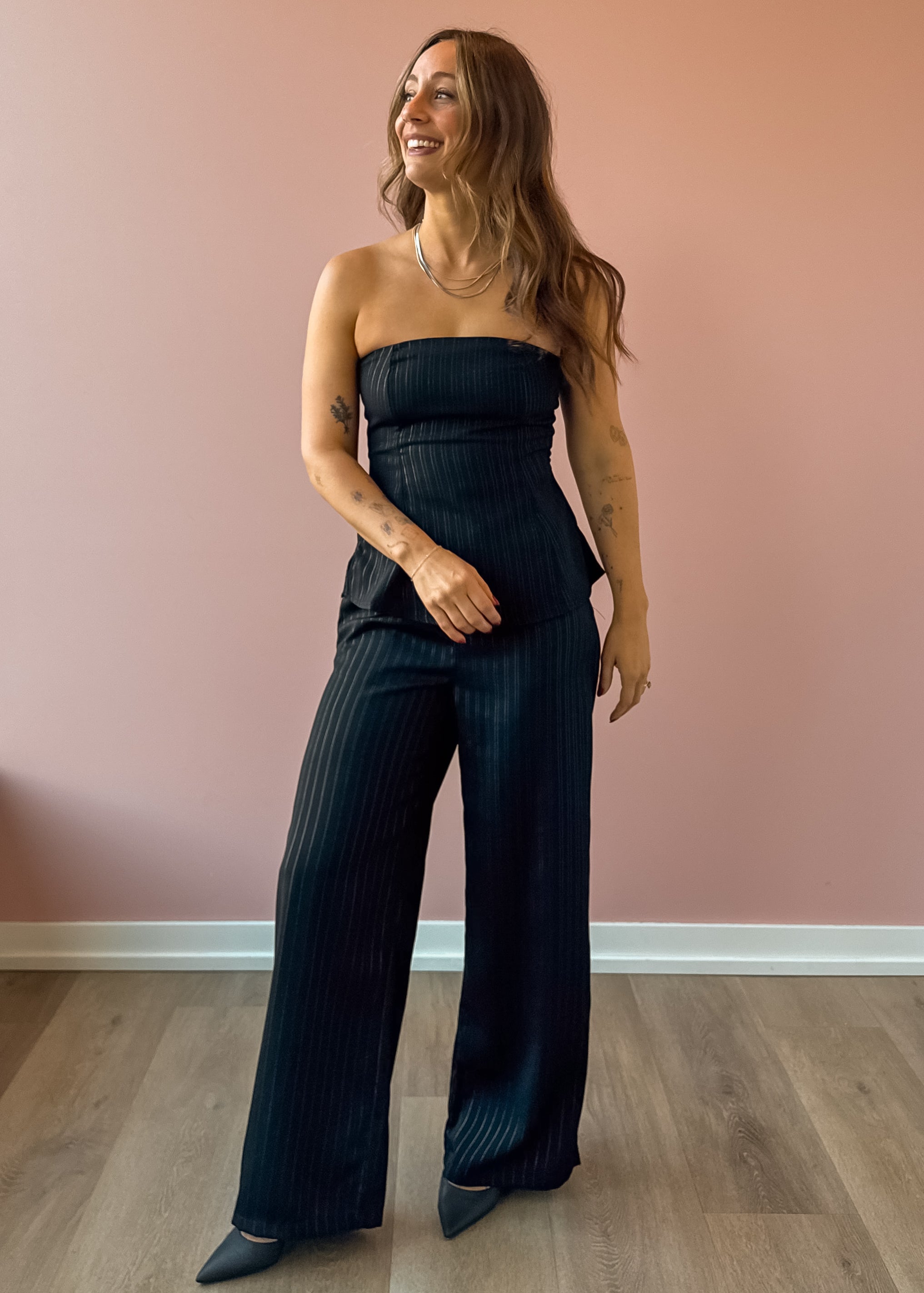 Sadie & Sage Gilded Evening Pinstripe Pants in black with silver pinstripes, full-length front view.