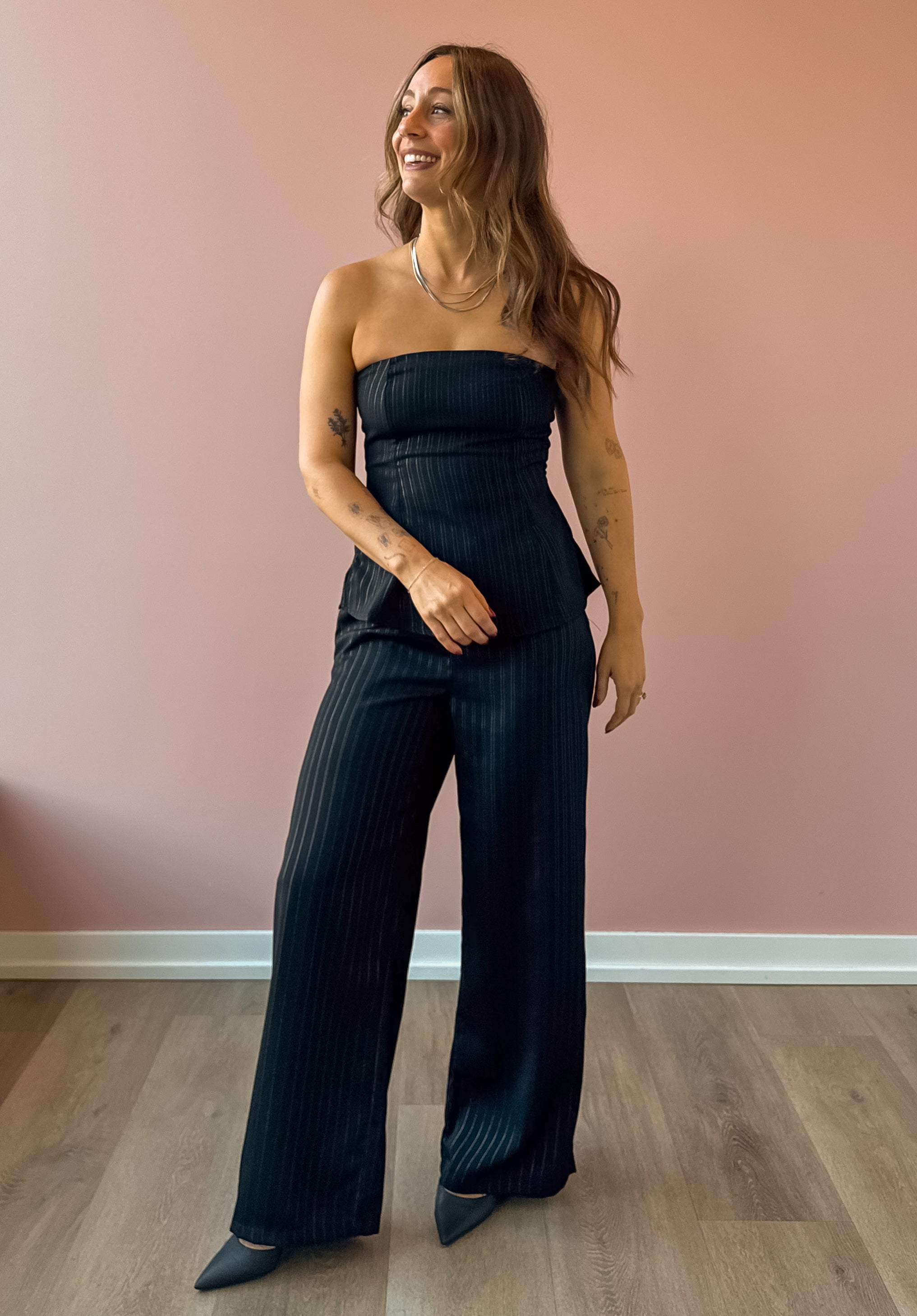 Sadie & Sage Gilded Evening Pinstripe Pants in black with silver pinstripes, full-length front view.