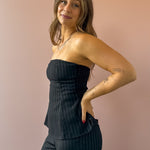 Sadie & Sage Gilded Evening Pinstripe Tube Top in black with silver pinstripes, three-quarter close-up.