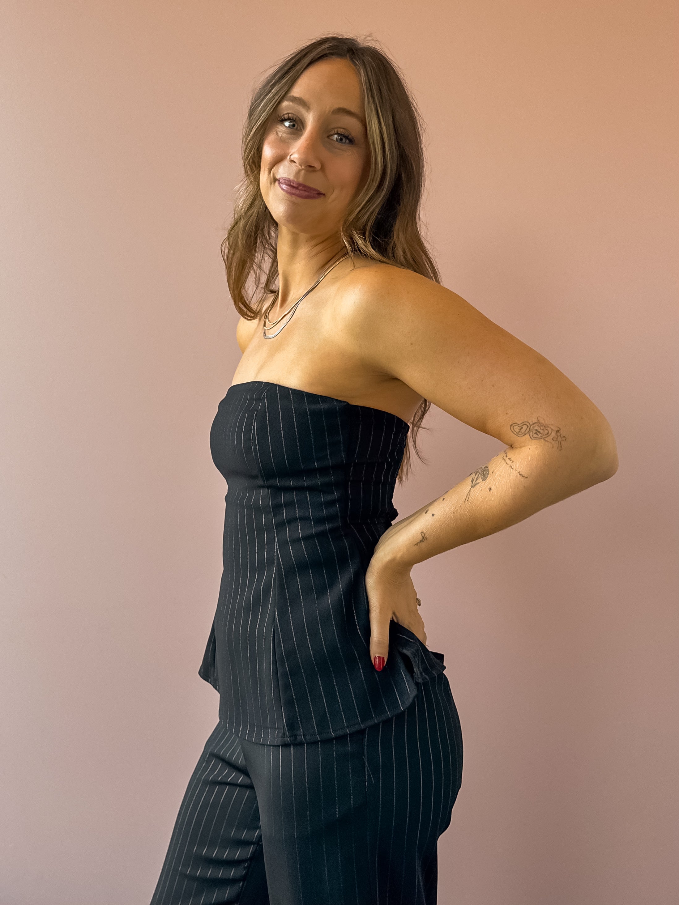 Sadie & Sage Gilded Evening Pinstripe Tube Top in black with silver pinstripes, three-quarter close-up.