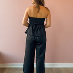Sadie & Sage Gilded Evening Pinstripe Pants in black with silver pinstripes, full-length back view.